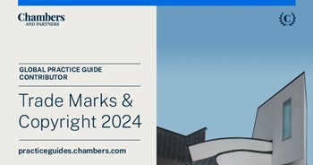 A person standing in front of a blue and white backgroundDescription automatically generated